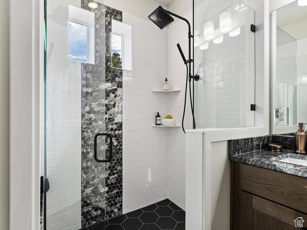 Bathroom featuring walk in shower and vanity