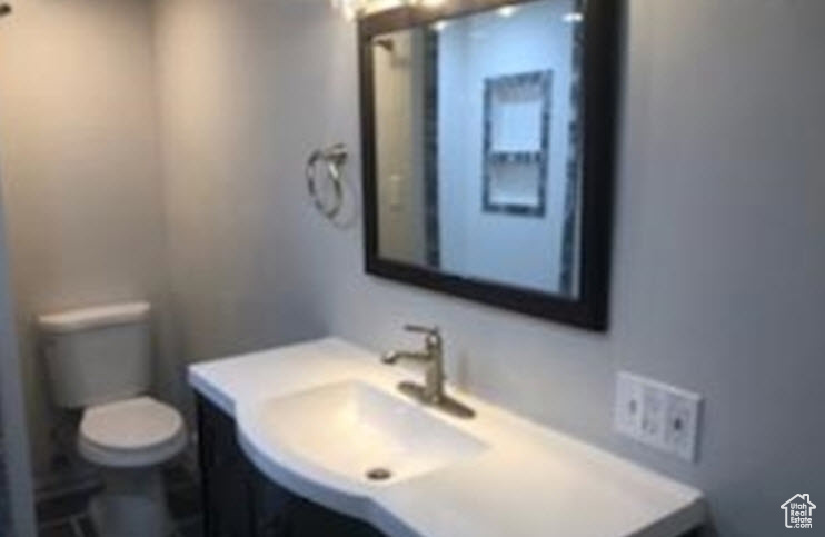 Basement Bathroom with vanity and toilet