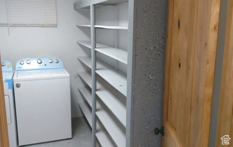 Basement Laundry room featuring separate washer and dryer