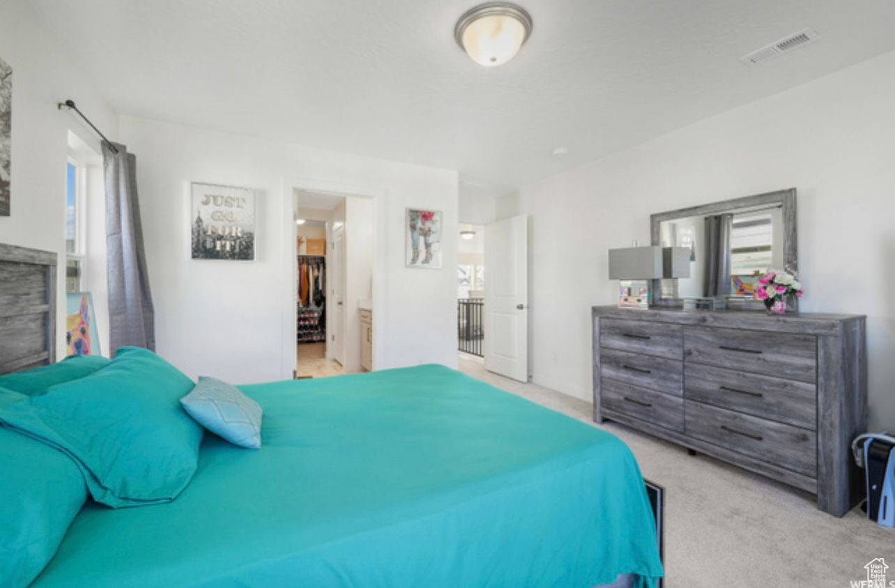 Bedroom with light colored carpet