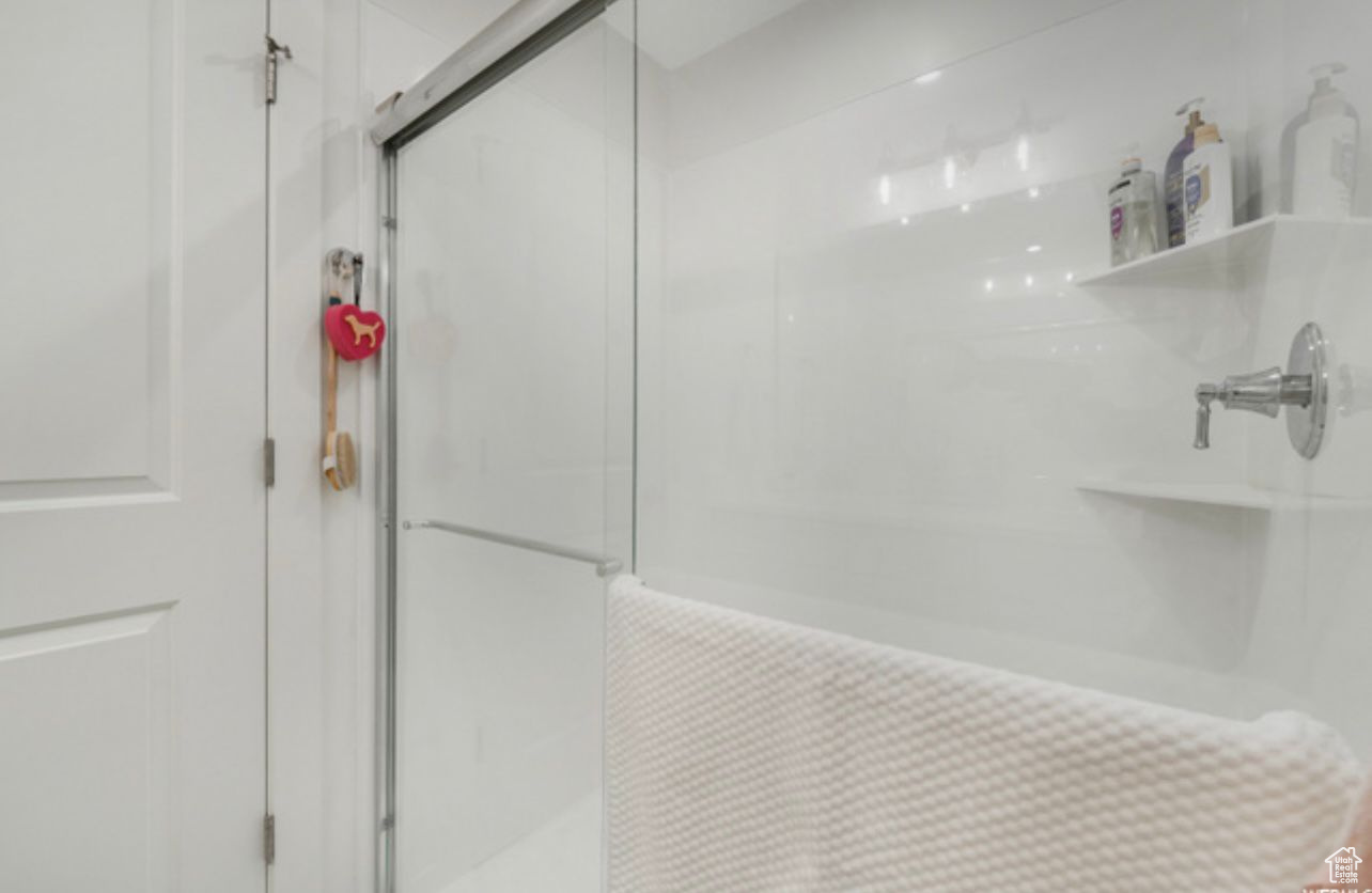 Bathroom featuring a shower with door