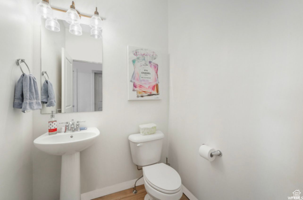 Bathroom featuring wood-type flooring and toilet