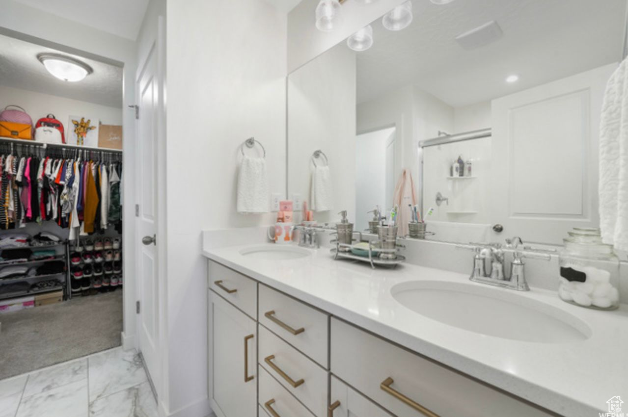 Bathroom with tile flooring and double vanity