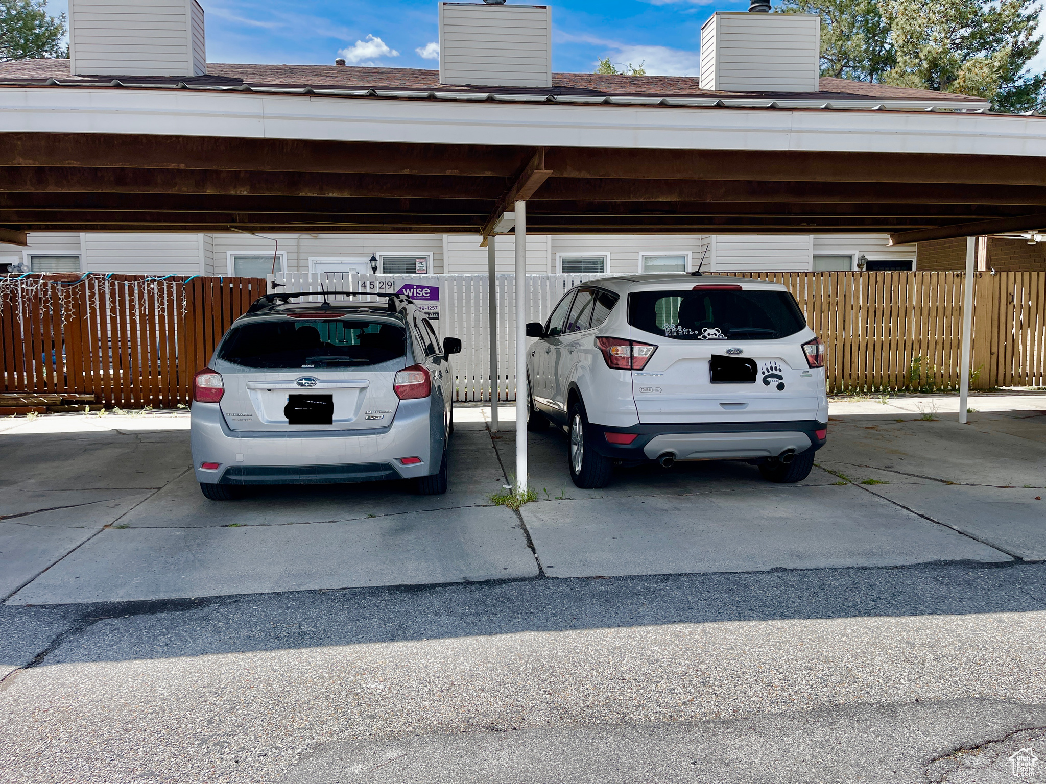 View of parking with a carport