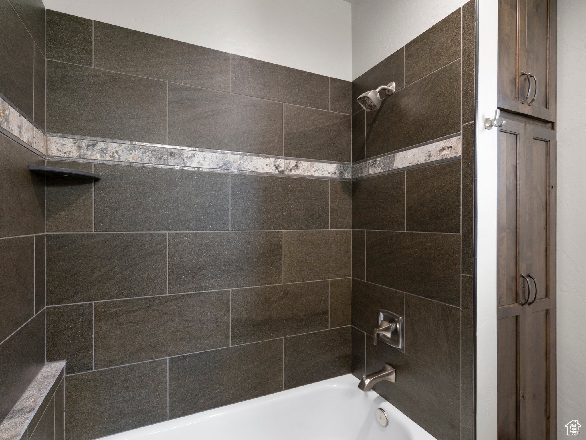 Bathroom shower/tub with custom tile work.