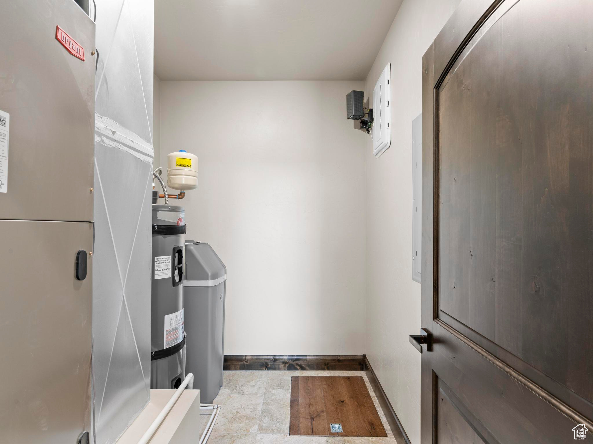 Fully finished utility room with water heater, high-efficiency furnace, water softener, access hatch to large crawlspace.