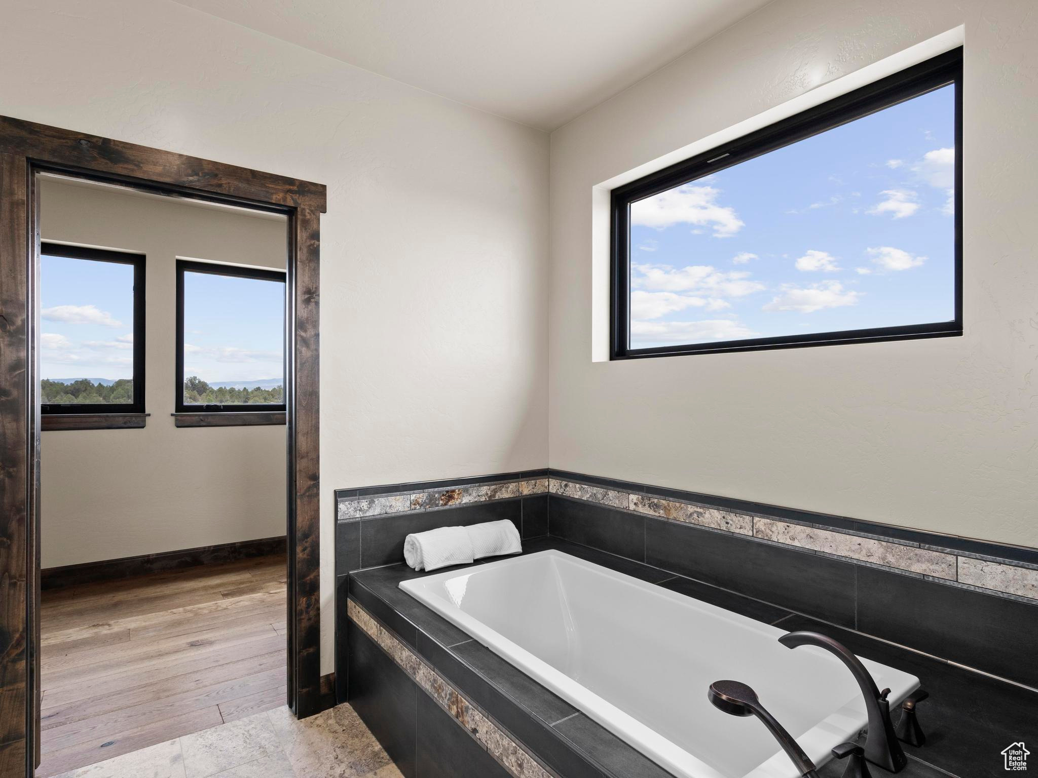 Owner's Suite with granite countertops, custom tile tub and shower surrounds, custom tile floors.