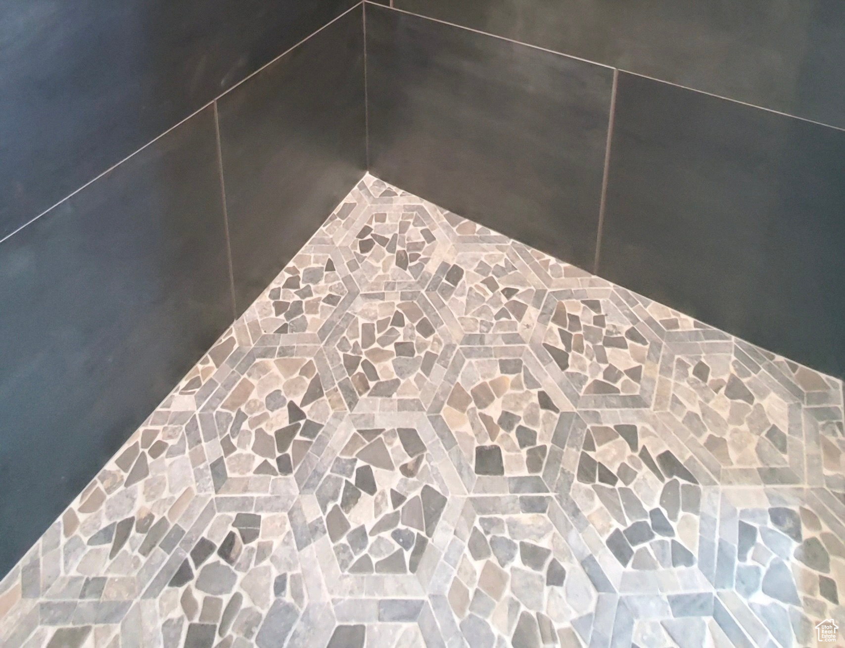 Owner's suite enlarged shower with custom tile work.