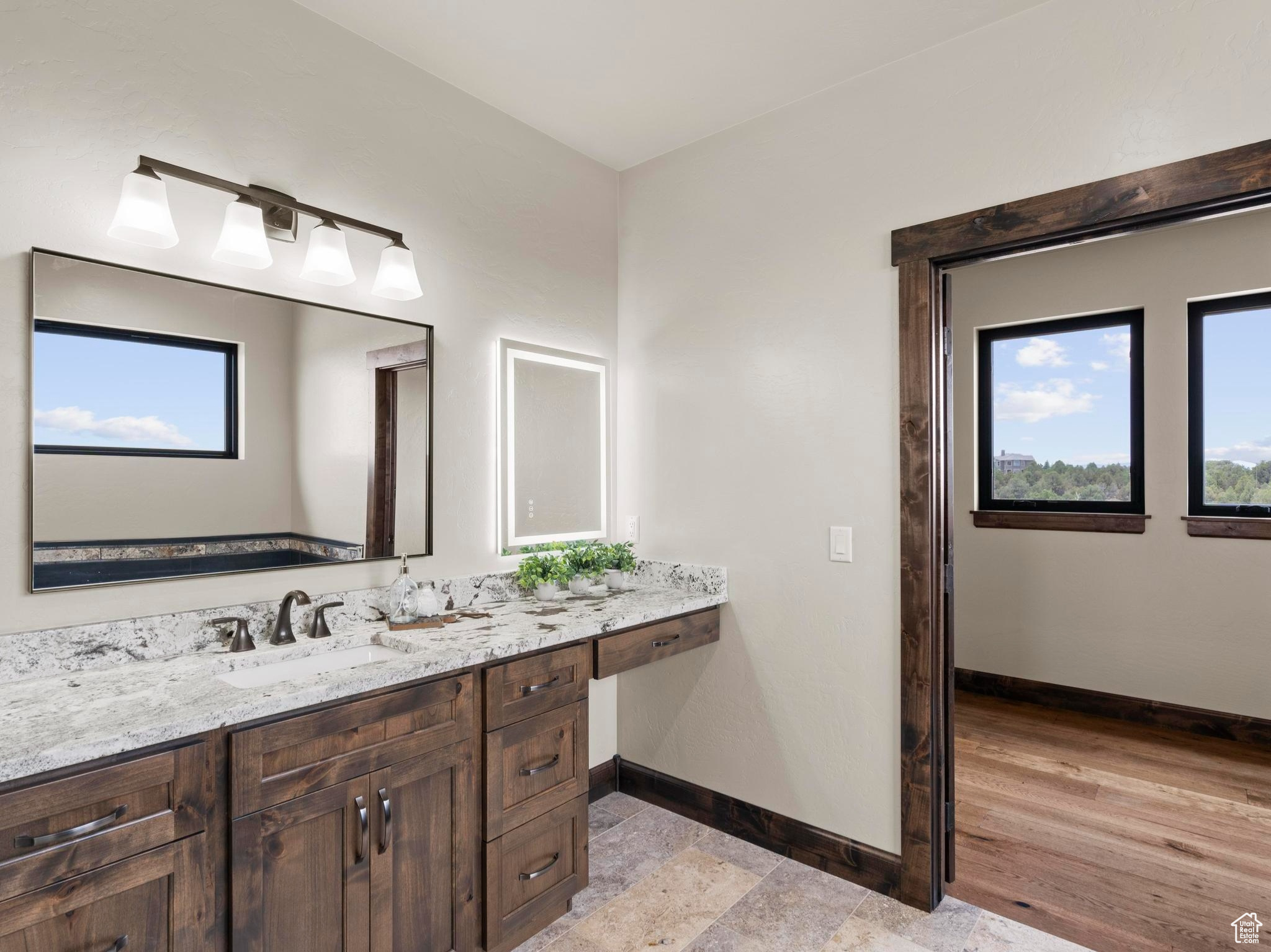 Owner's Suite with granite countertops, custom tile tub and shower surrounds, custom tile floors.