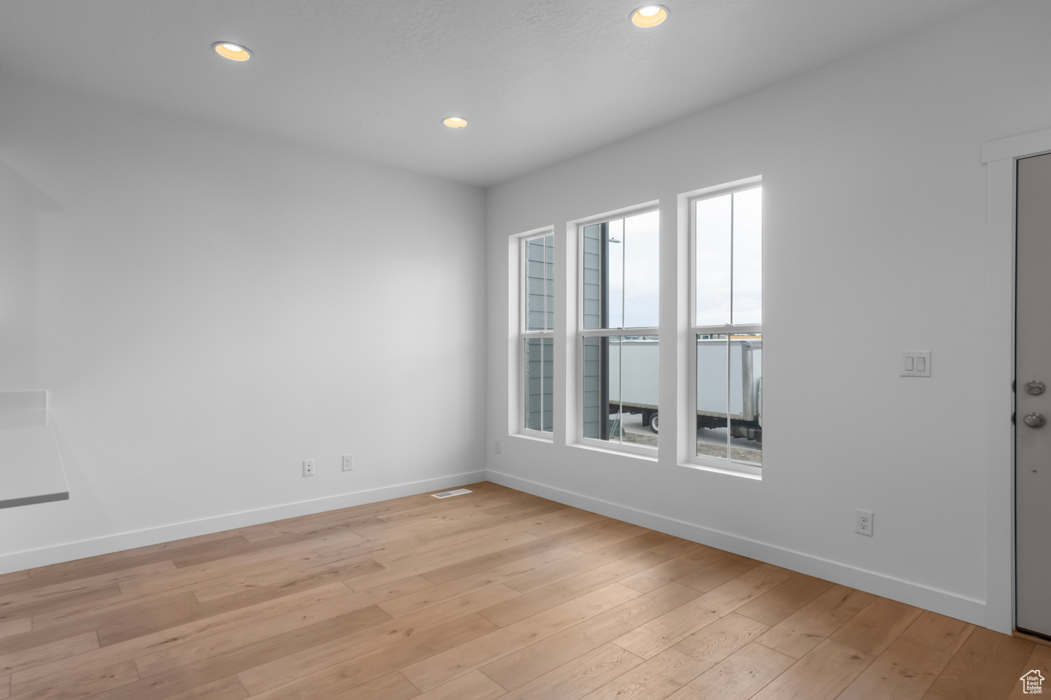 Spare room with plenty of natural light and light hardwood / wood-style flooring