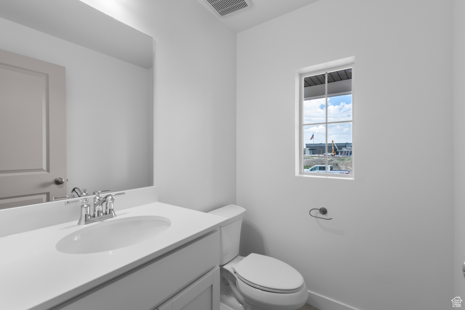 Bathroom with toilet and large vanity