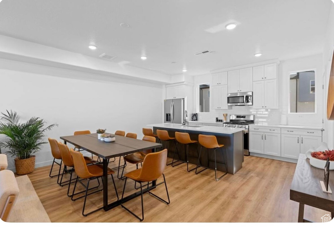 Dining room featuring sink and light wood-type flooring