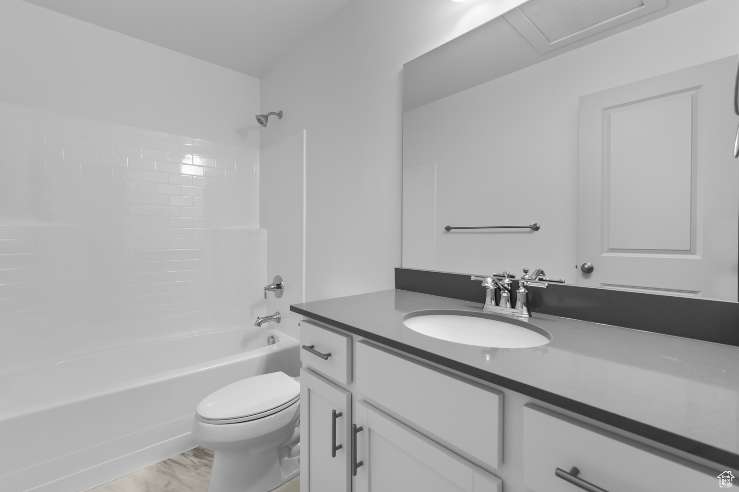 Full bathroom with wood-type flooring, vanity, toilet, and  shower combination