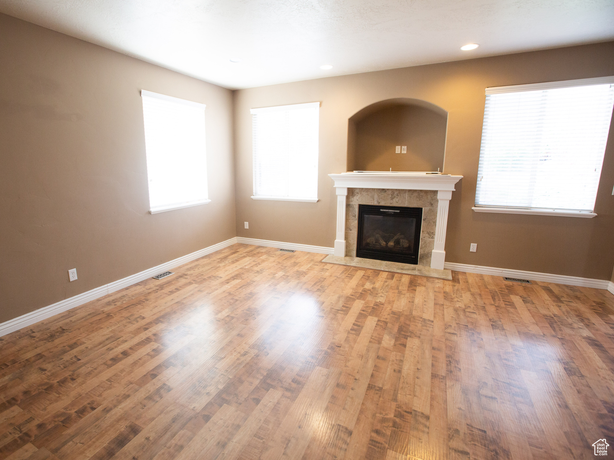 Unfurnished living room featuring a fireplace and hardwood / wood-style flooring