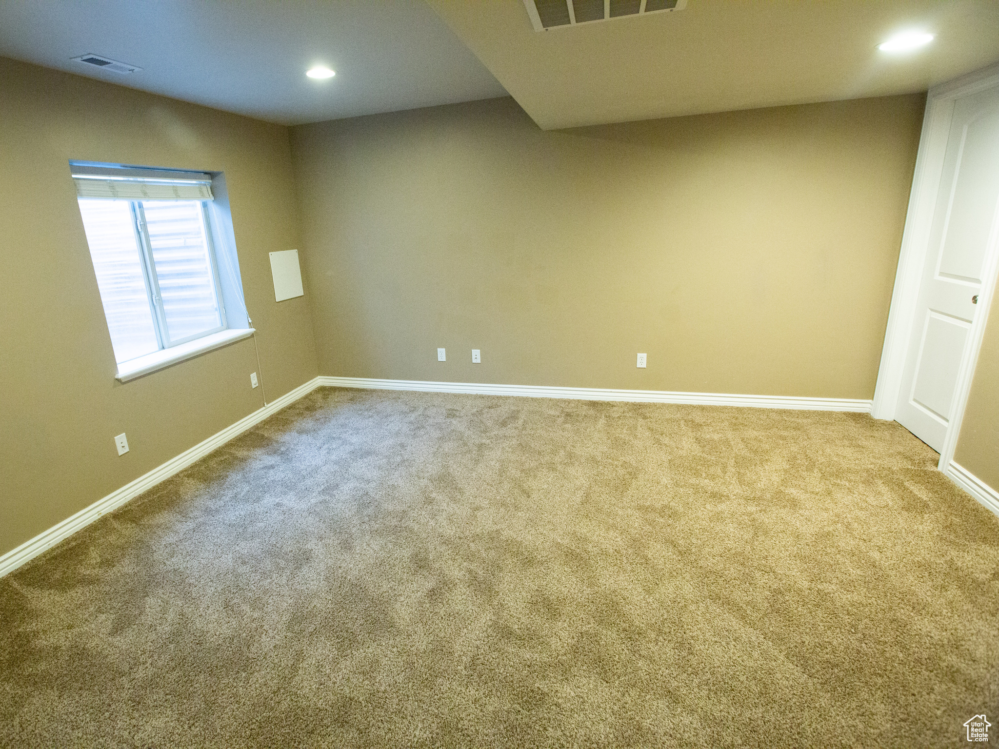 Spare room featuring carpet flooring