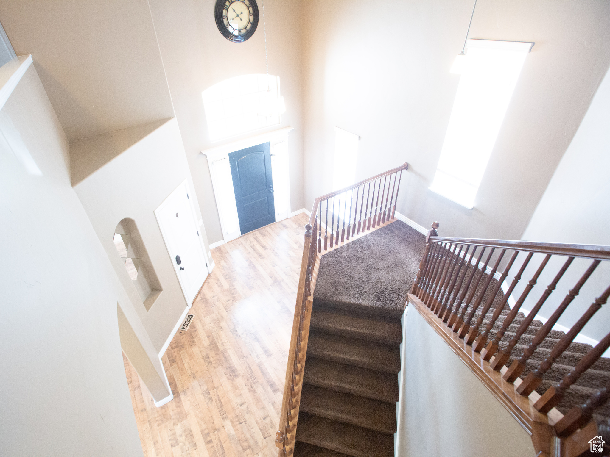 Stairway featuring a high ceiling and hardwood / wood-style floors