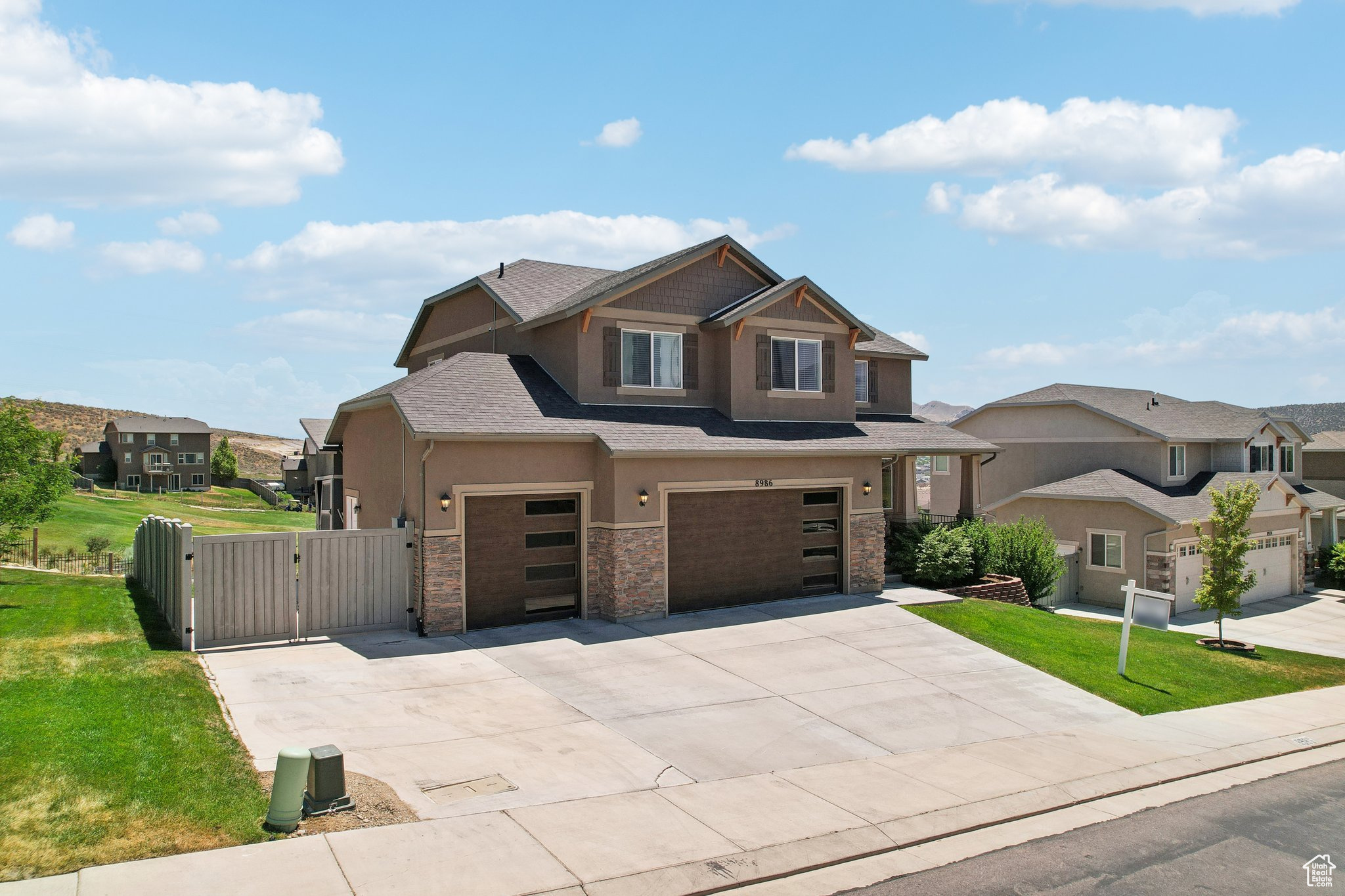 View of front of house with a front lawn and a 3 garage