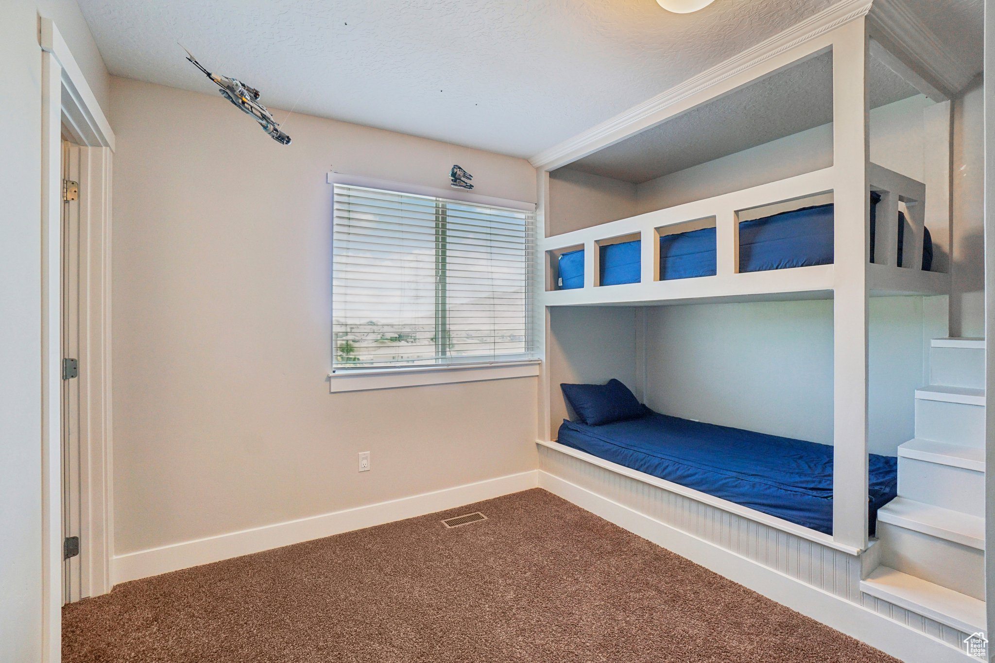 Unfurnished bedroom with carpet flooring