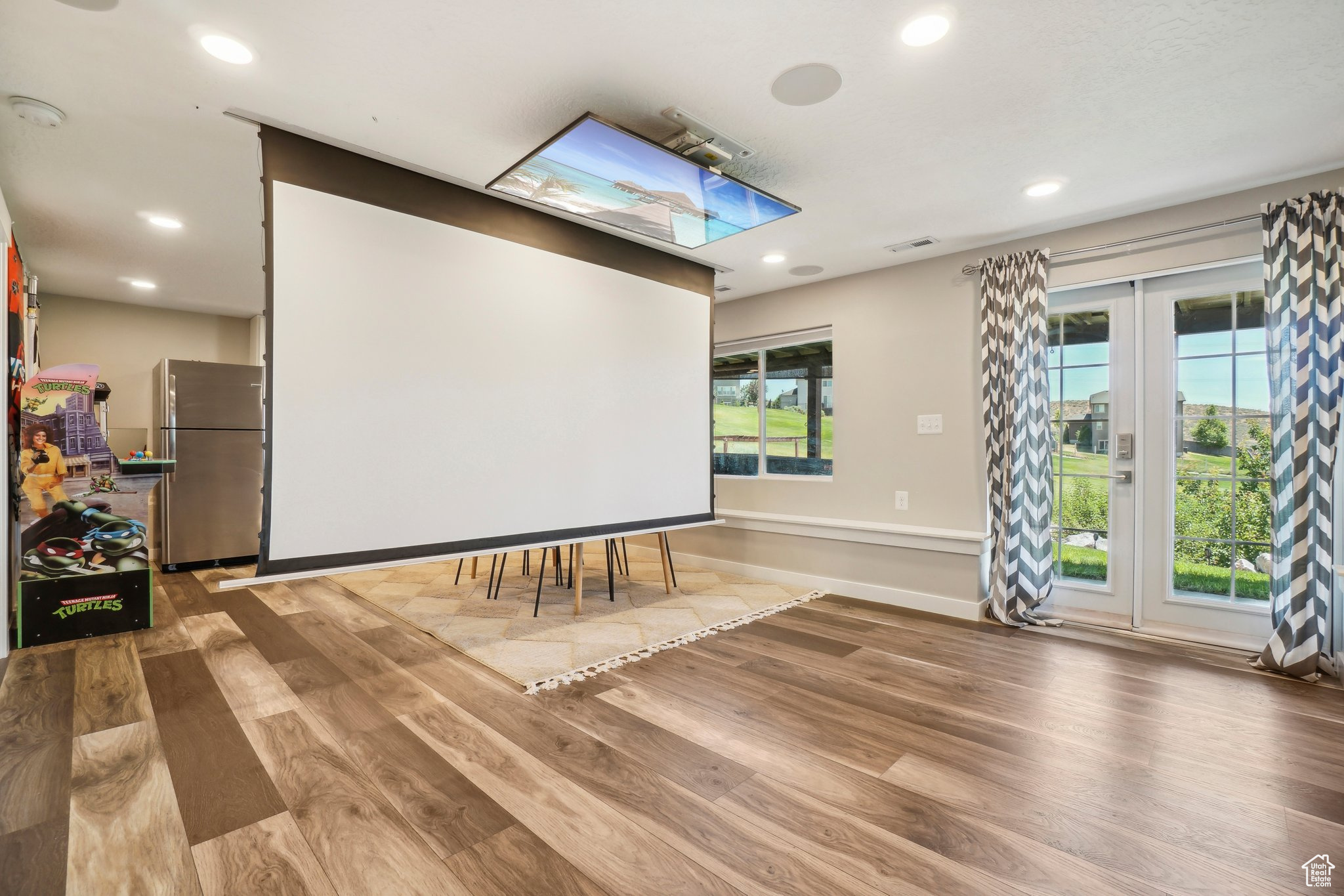 Home theater room featuring a wealth of natural light and wood-type flooring