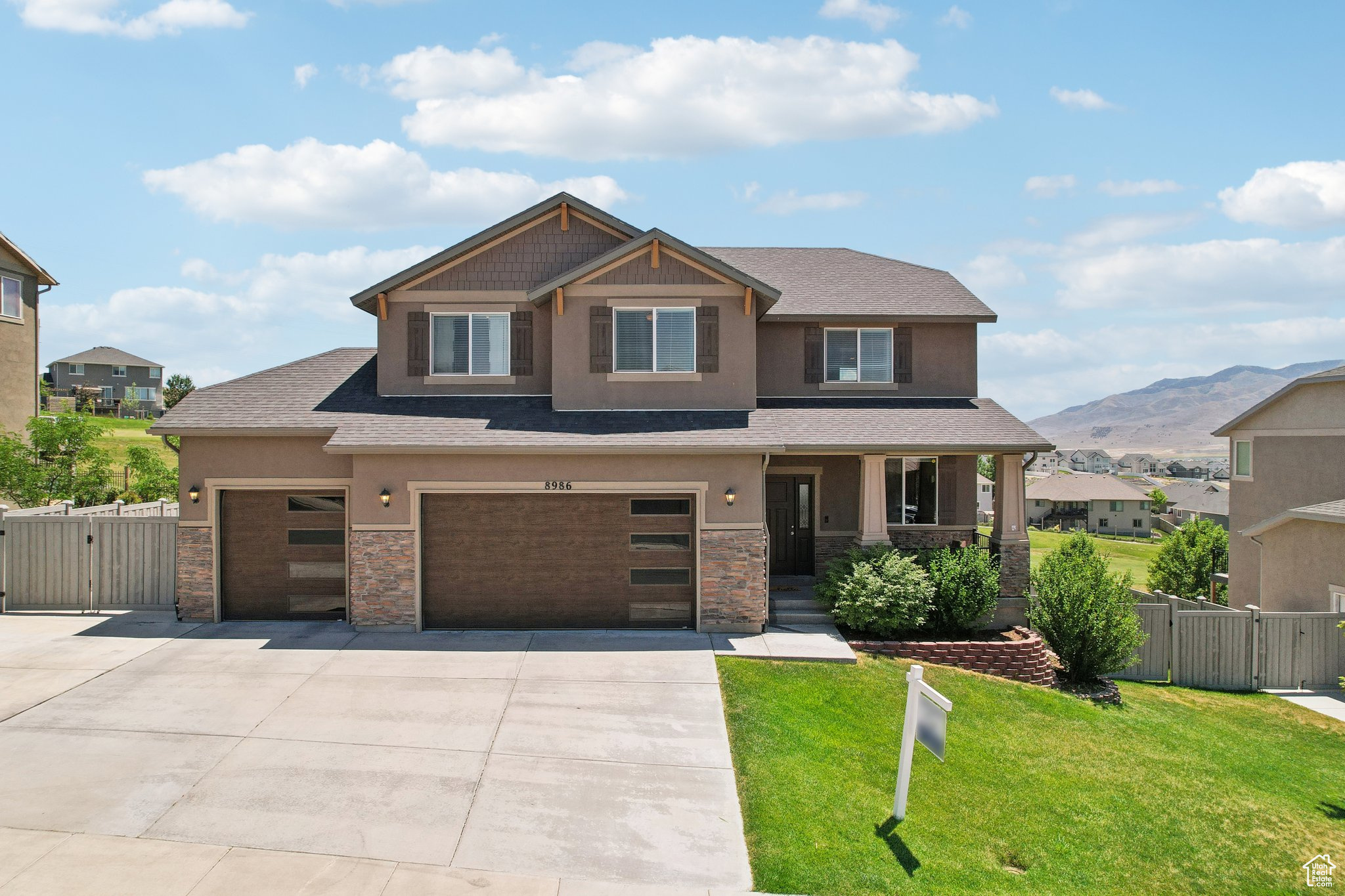 Craftsman-style house featuring a garage, a mountain view, and a front lawn