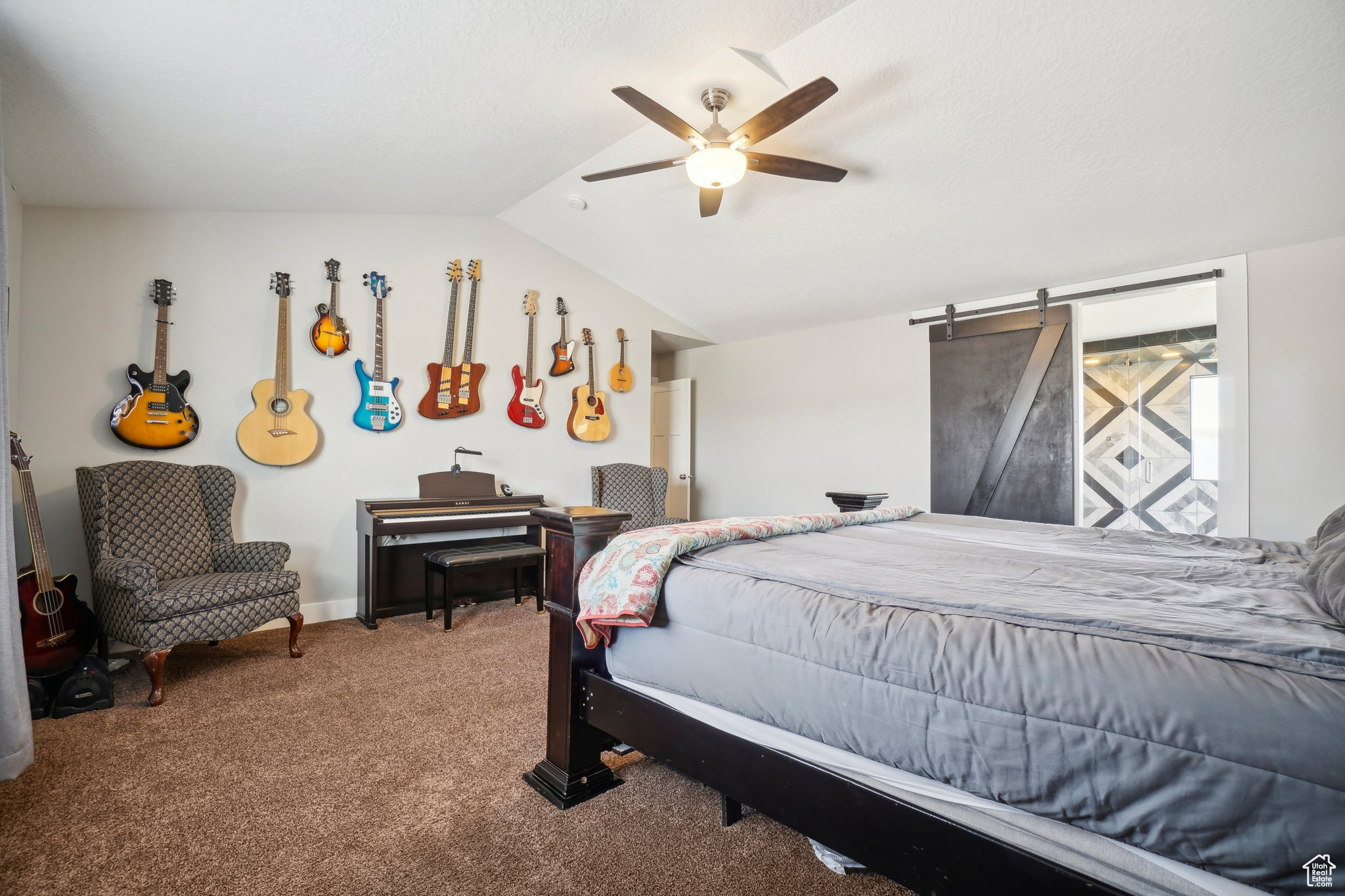 Bedroom featuring carpet, ceiling fan, and vaulted ceiling