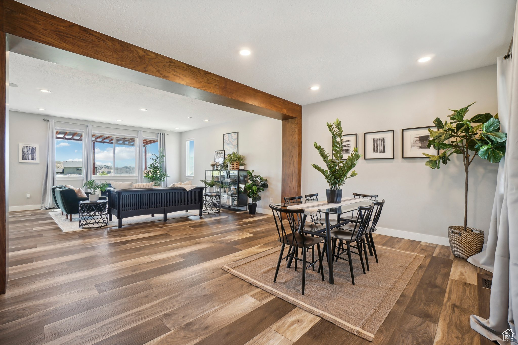 Dining room with beam ceiling and wood-type flooring