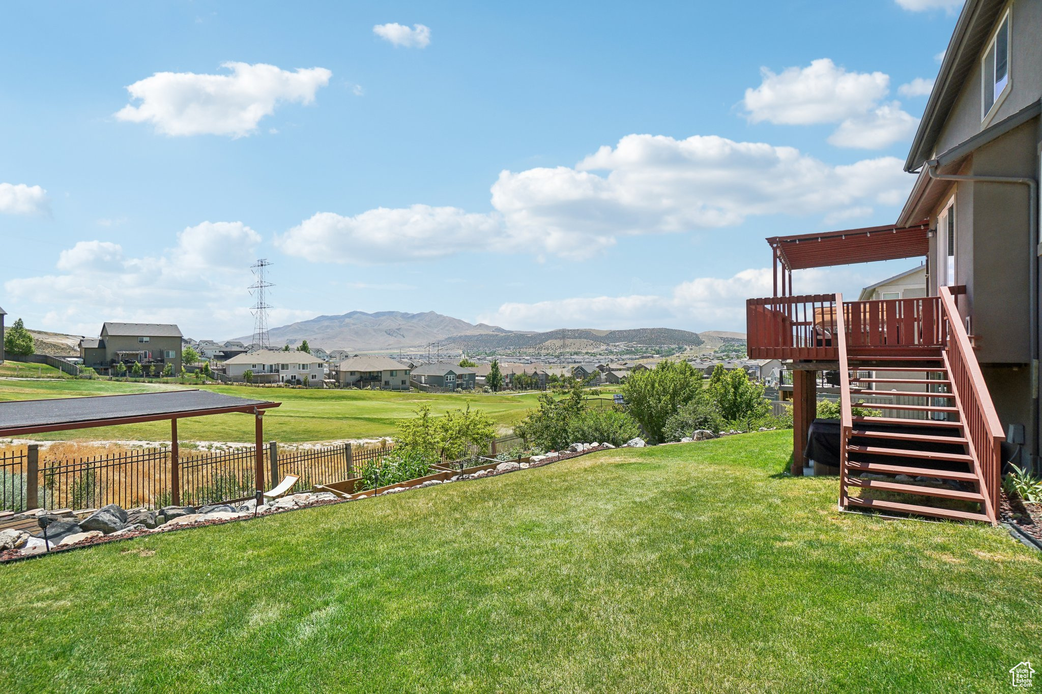 View of yard with a deck with mountain view