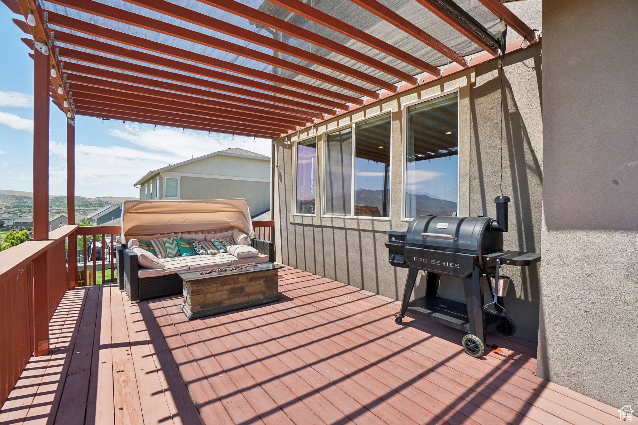 Wooden deck featuring a pergola and grilling area