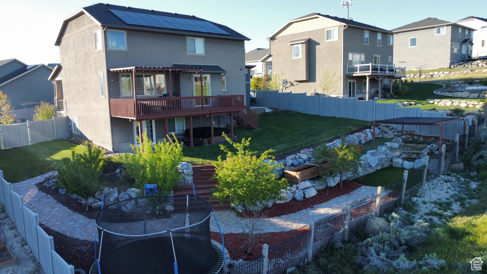 Back of house featuring a deck and a yard