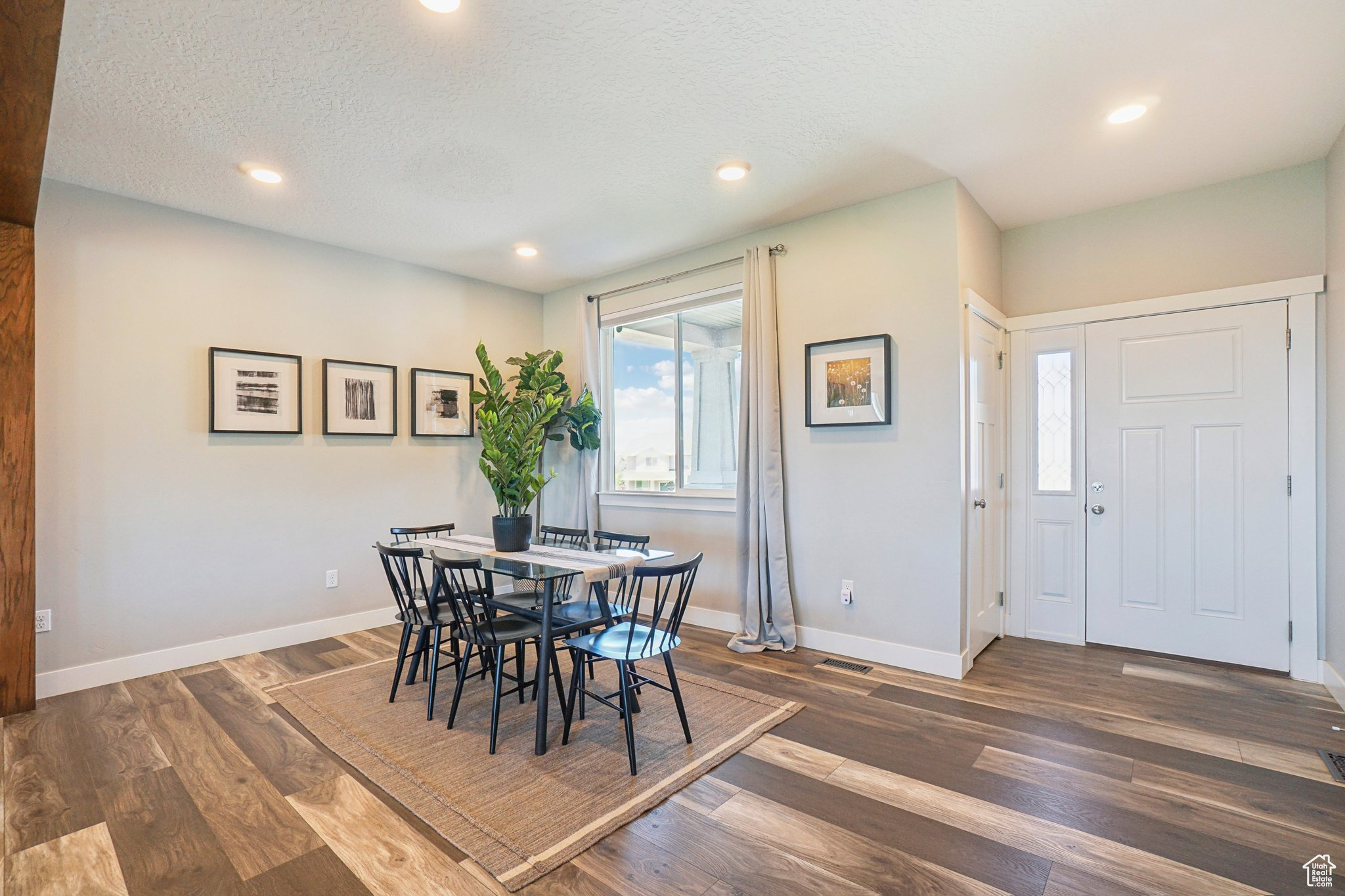 Dining area featuring dark hardwood / wood-style flooring and a textured ceiling