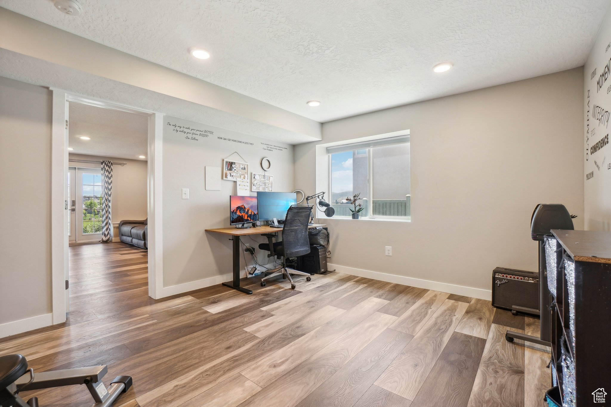 Office area featuring hardwood / wood-style floors and a textured ceiling