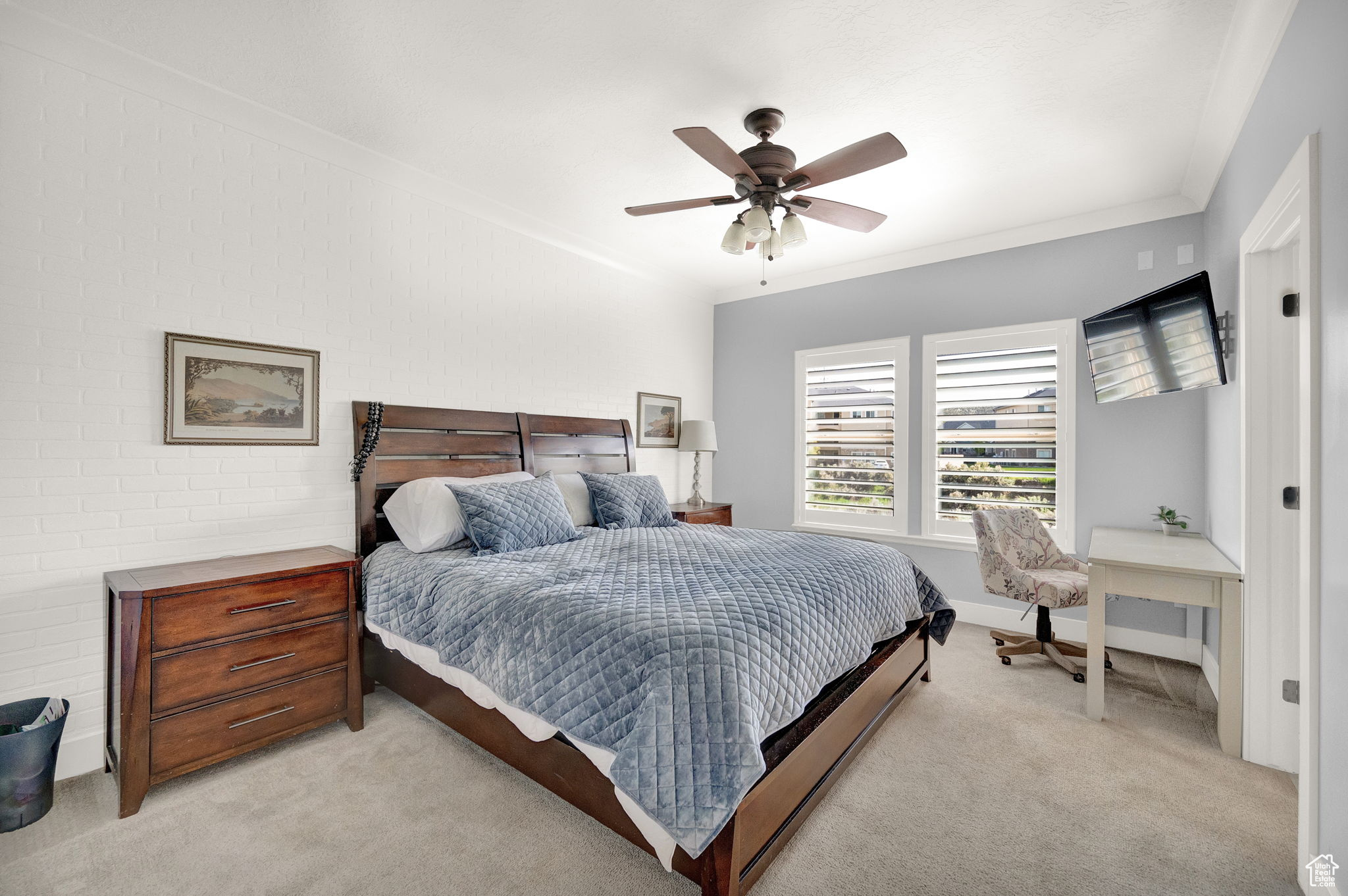 Bedroom with light colored carpet, ceiling fan, and ornamental molding
