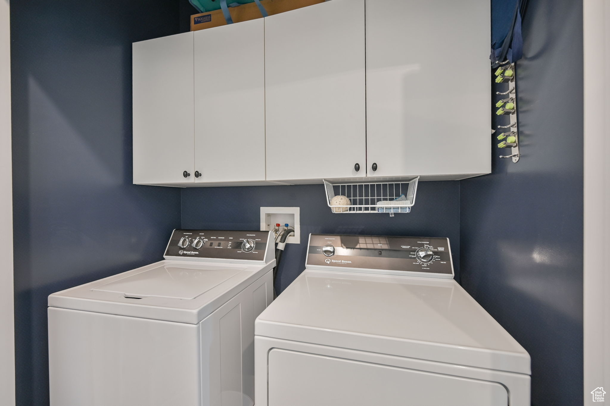 Laundry area with cabinets, washer hookup, and washing machine and clothes dryer