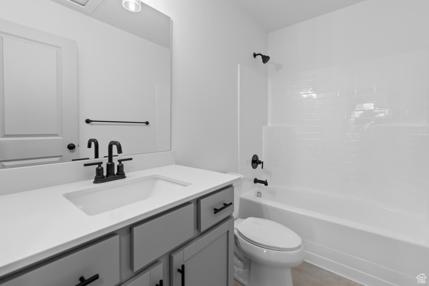 Full bathroom with  shower combination, vanity, and toilet