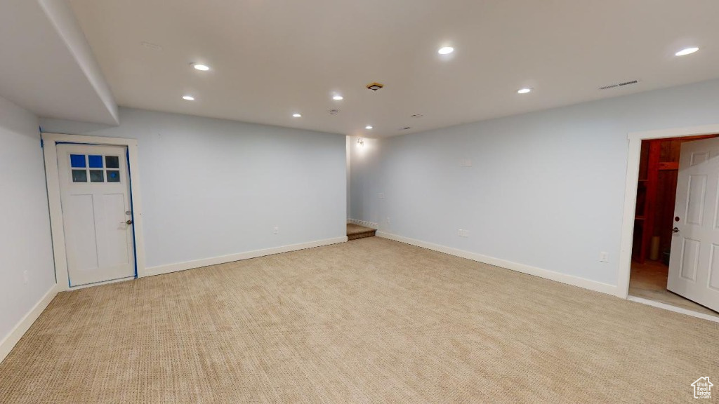 Spacious family room at the bottom of the stairs int he basement