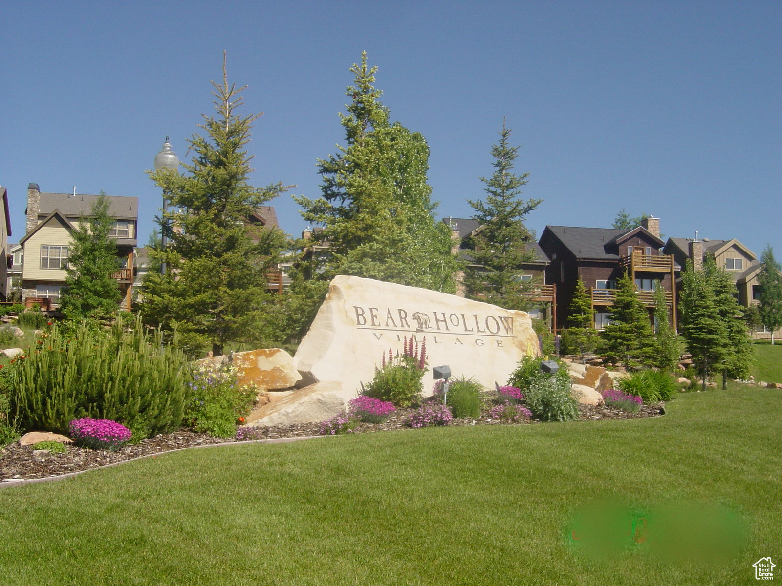 Community / neighborhood sign featuring a lawn