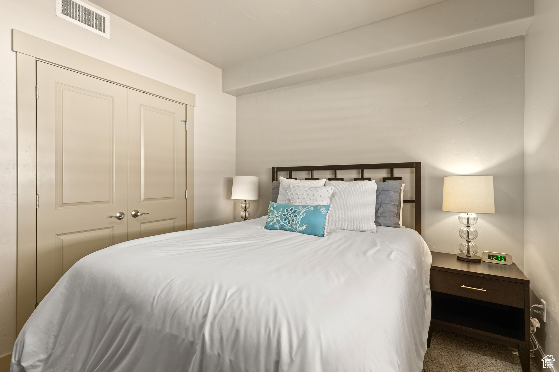 Carpeted bedroom with a closet