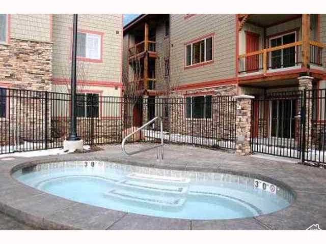 View of swimming pool featuring a community hot tub