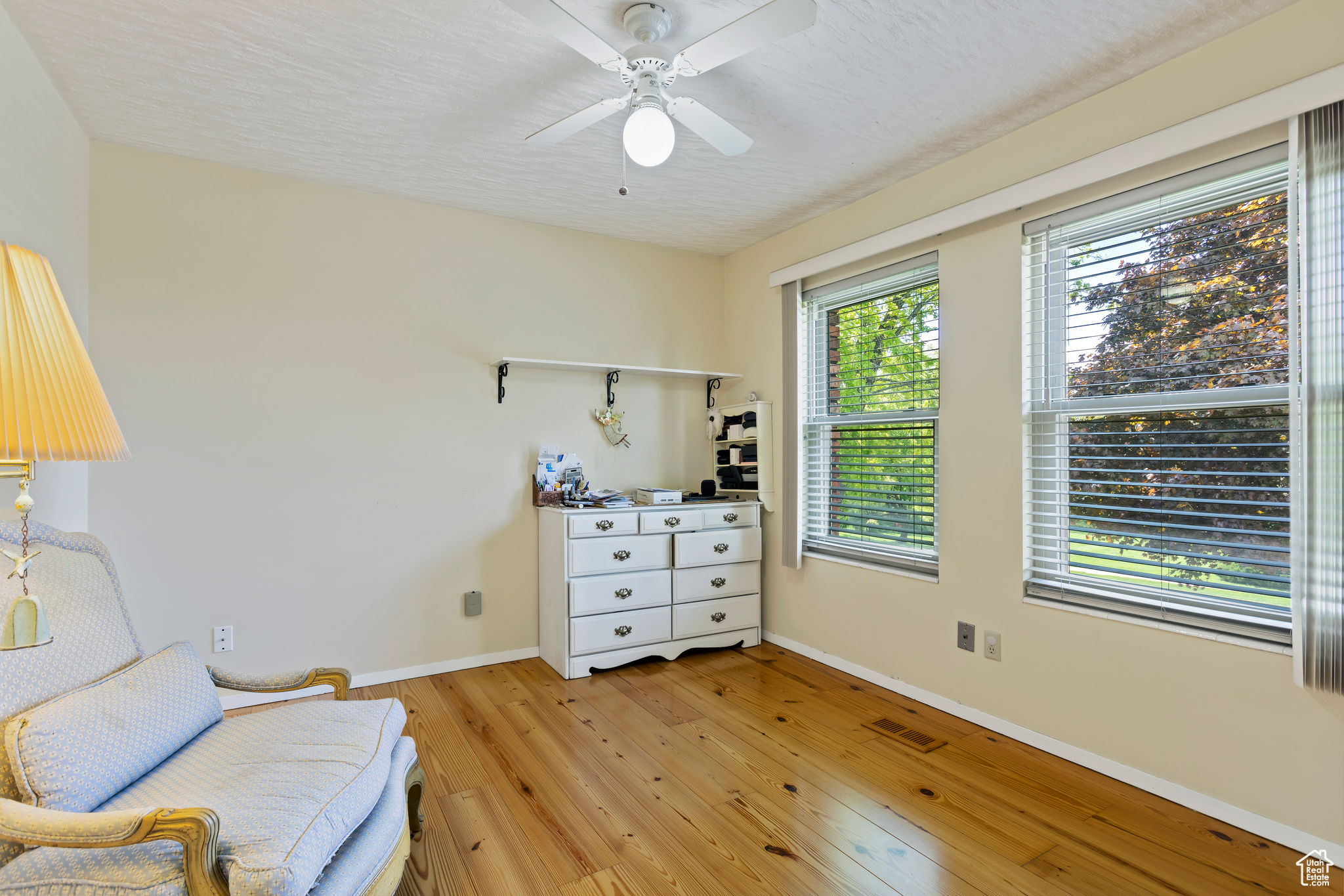 Sitting room featuring ceiling fan and light hardwood / wood-style floors