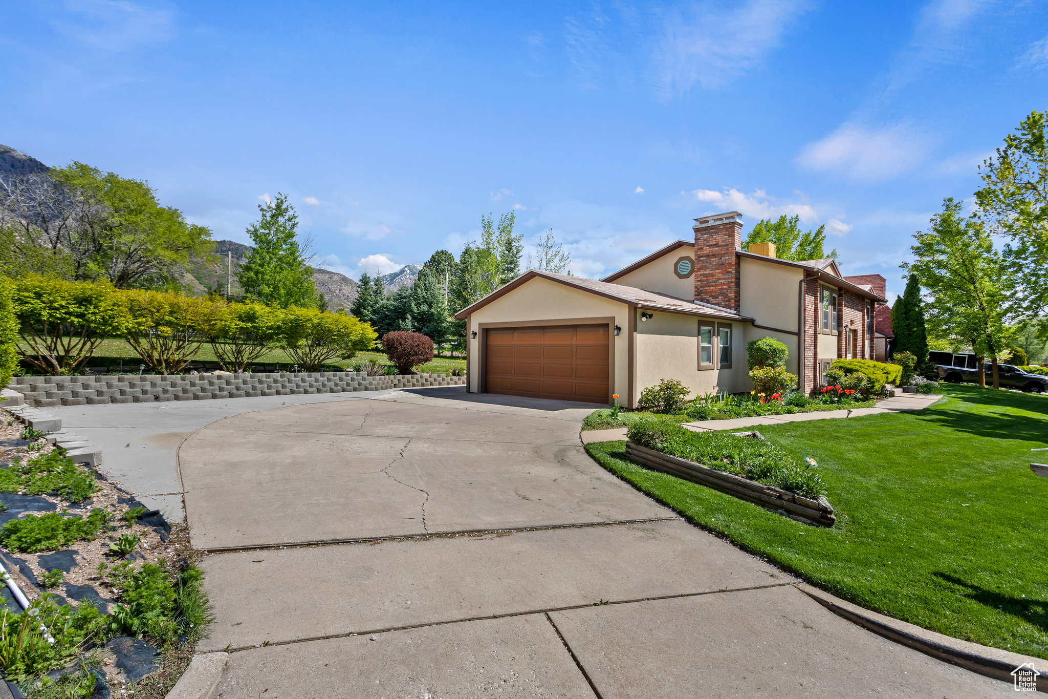 View of front of home featuring a garage and a front yard