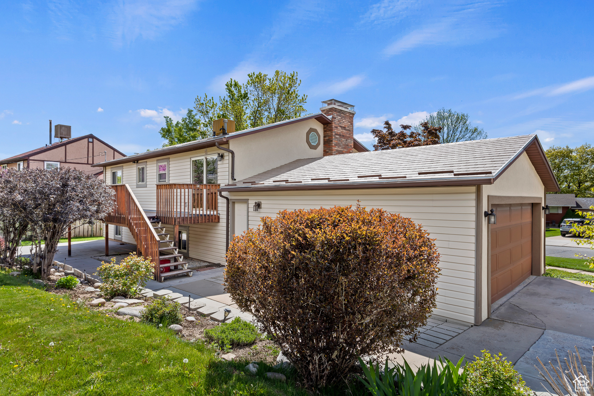 Exterior space featuring a wooden deck and a garage