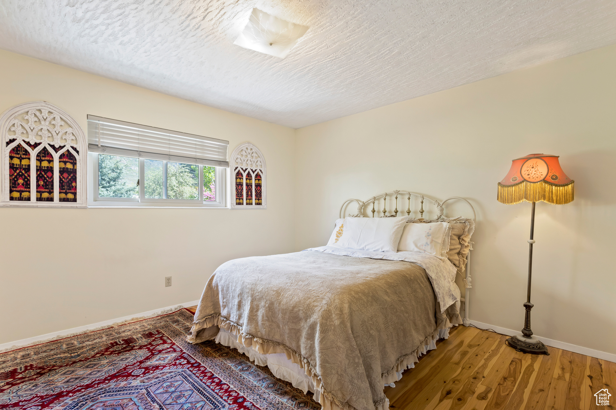 Bedroom featuring wood-type flooring and a textured ceiling