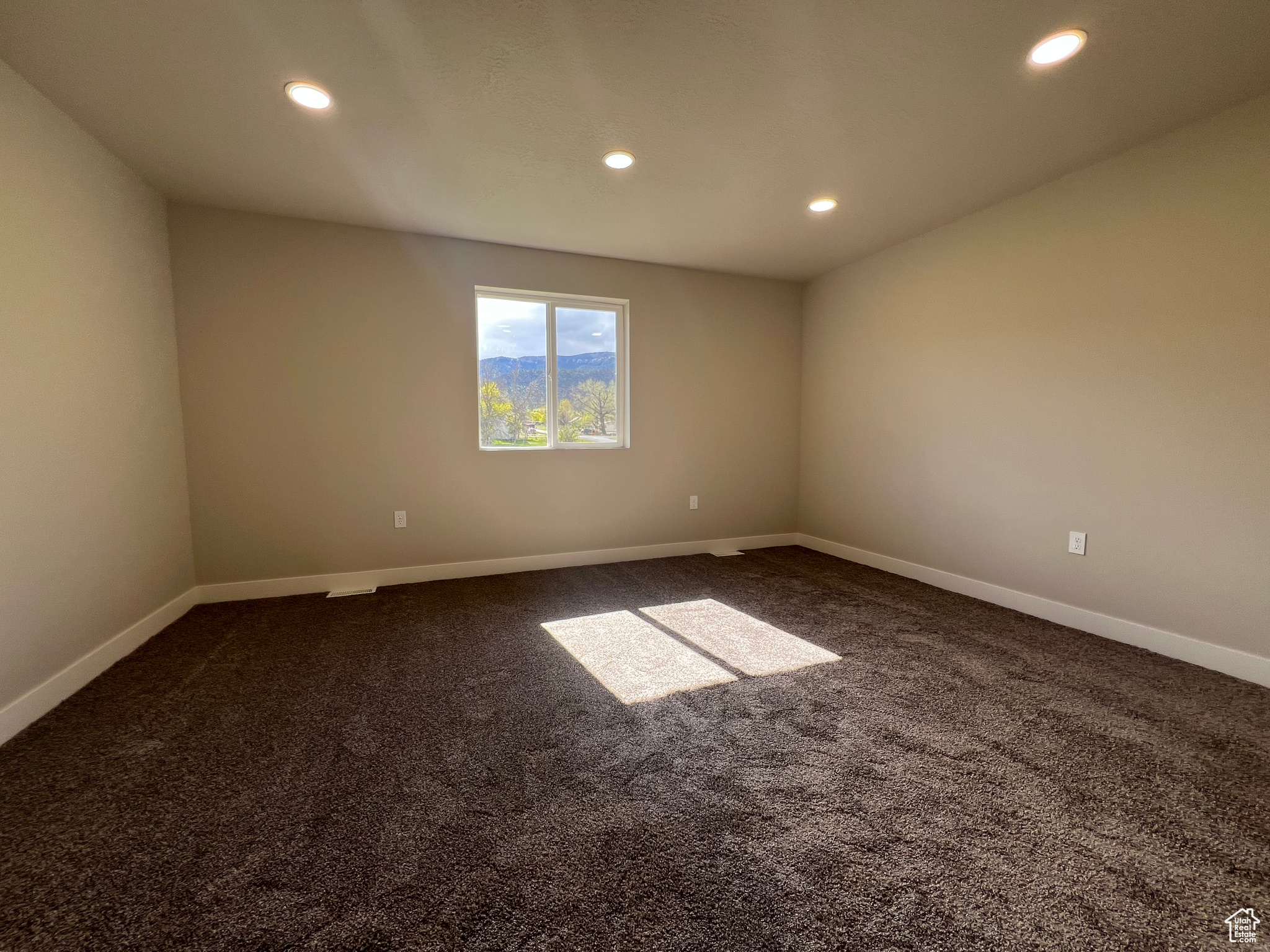 Spare room featuring carpet