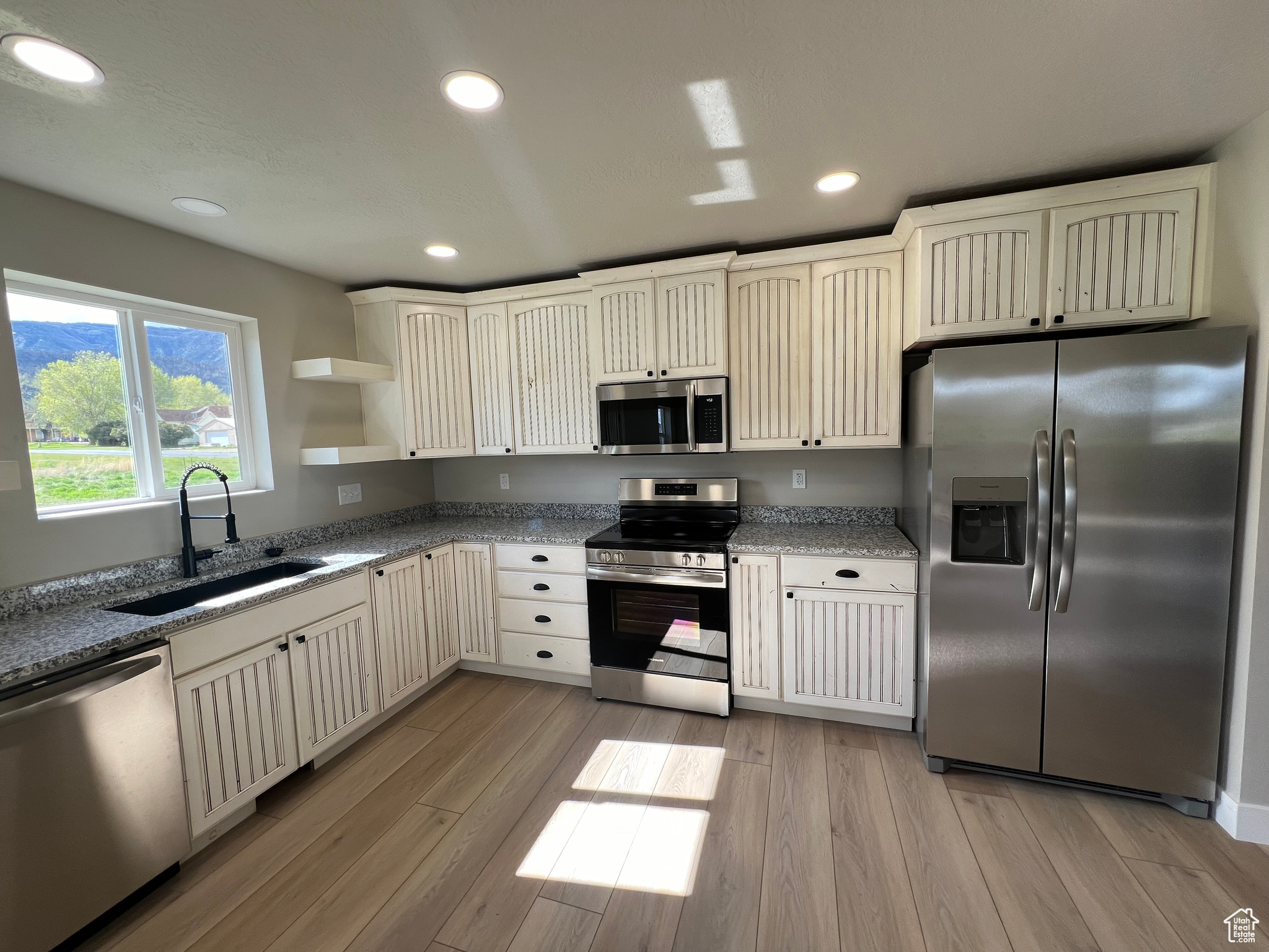 Kitchen featuring sink, appliances with stainless steel finishes, and light wood-type flooring