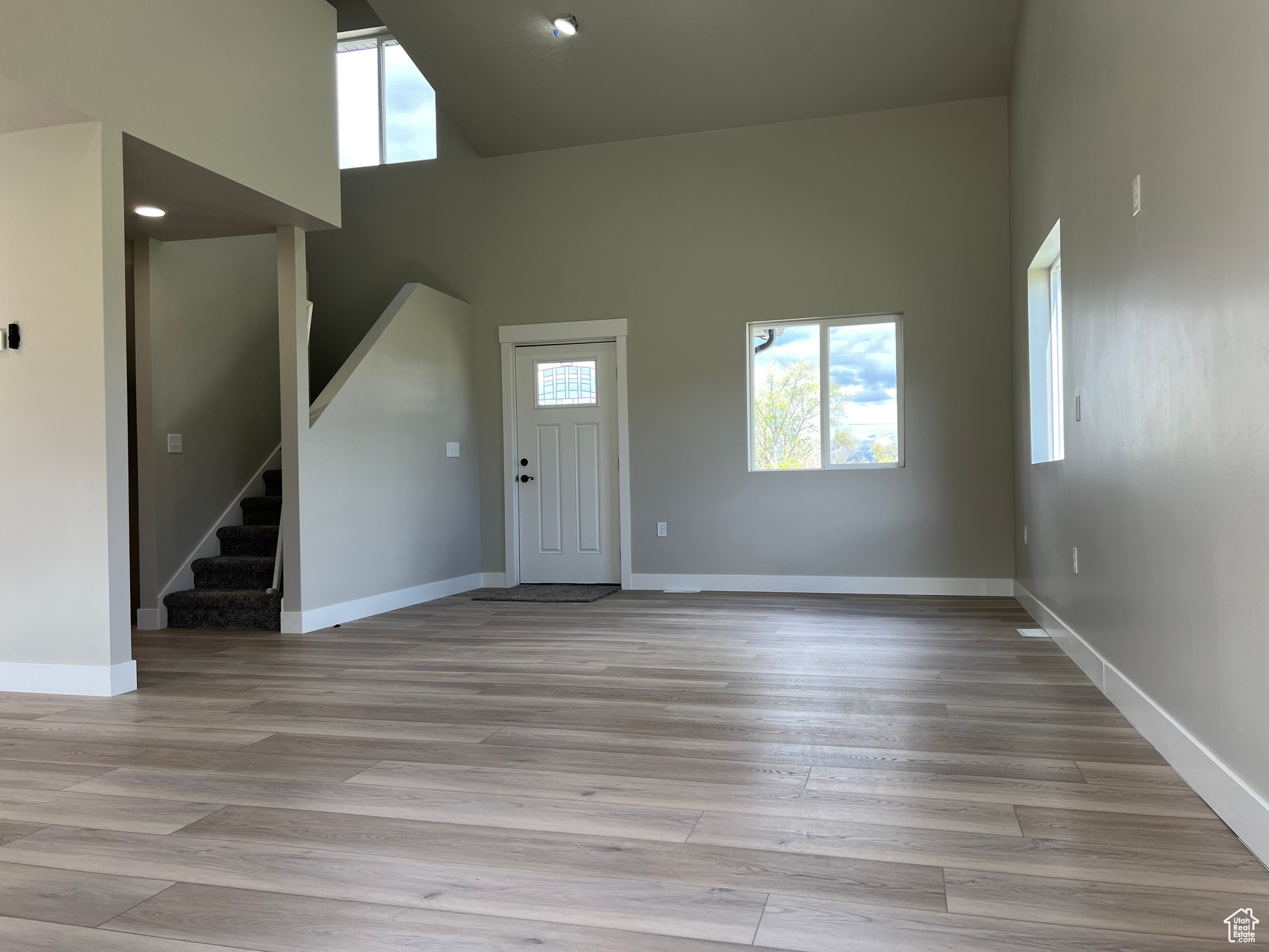 Foyer entrance with wood-type flooring and a high ceiling