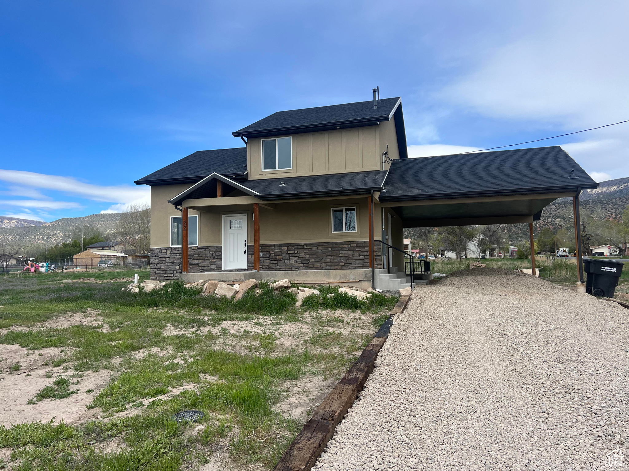 View of front facade featuring a carport and a mountain view