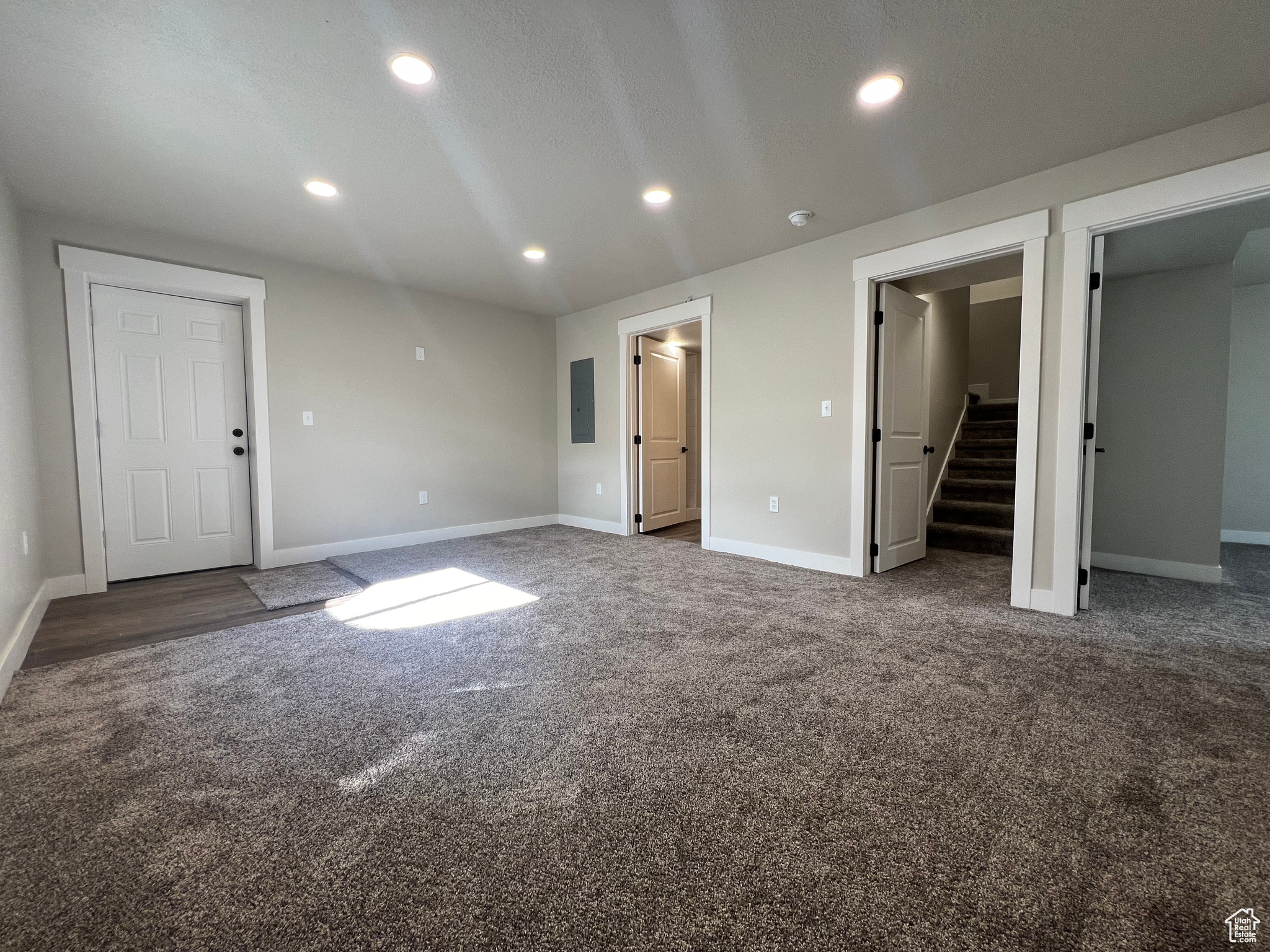 Unfurnished bedroom featuring dark carpet