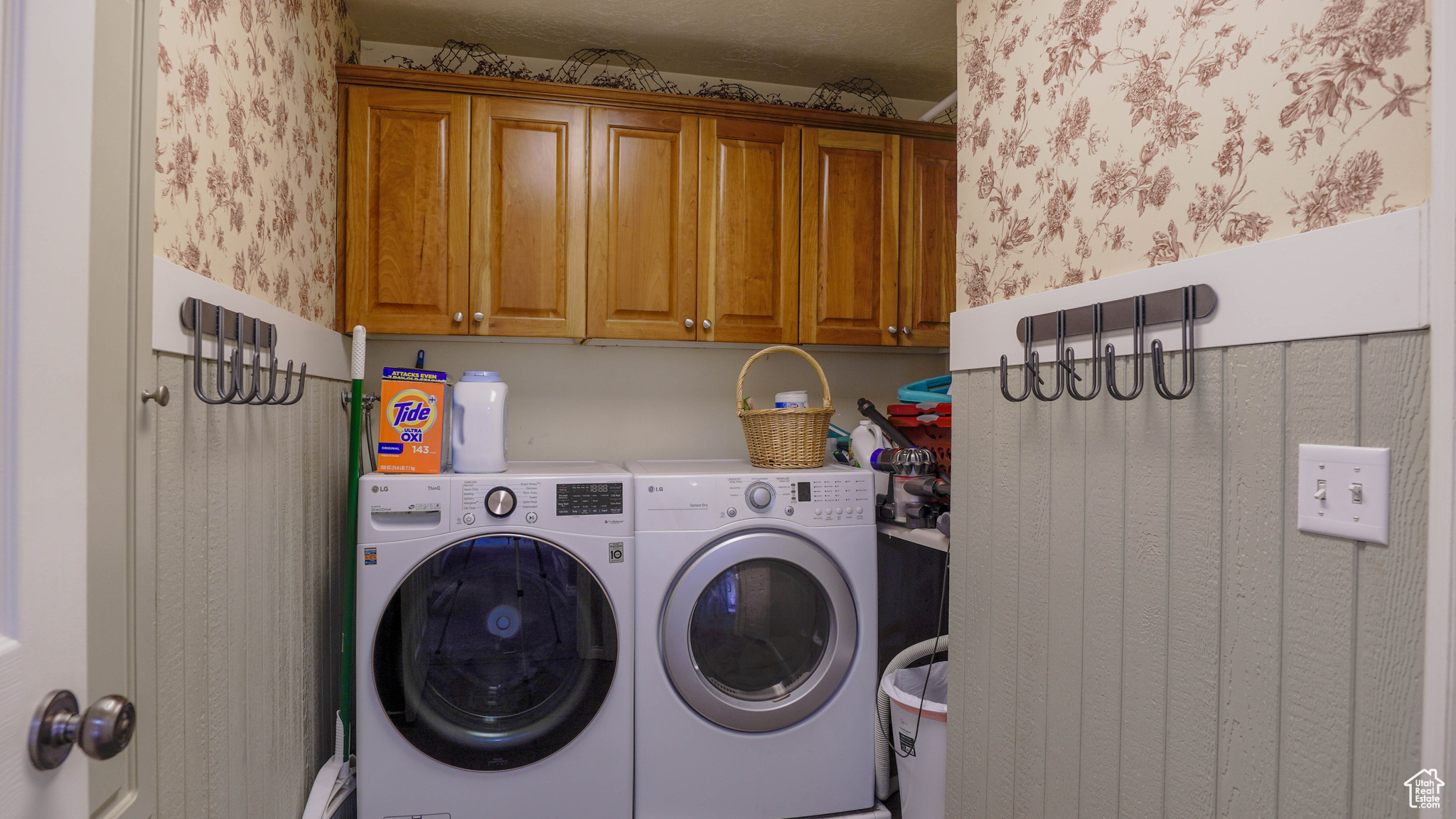 Washroom with Cabinets and Washer and Dryer.