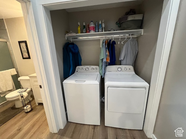 Laundry area featuring light hardwood / wood-style floors and independent washer and dryer