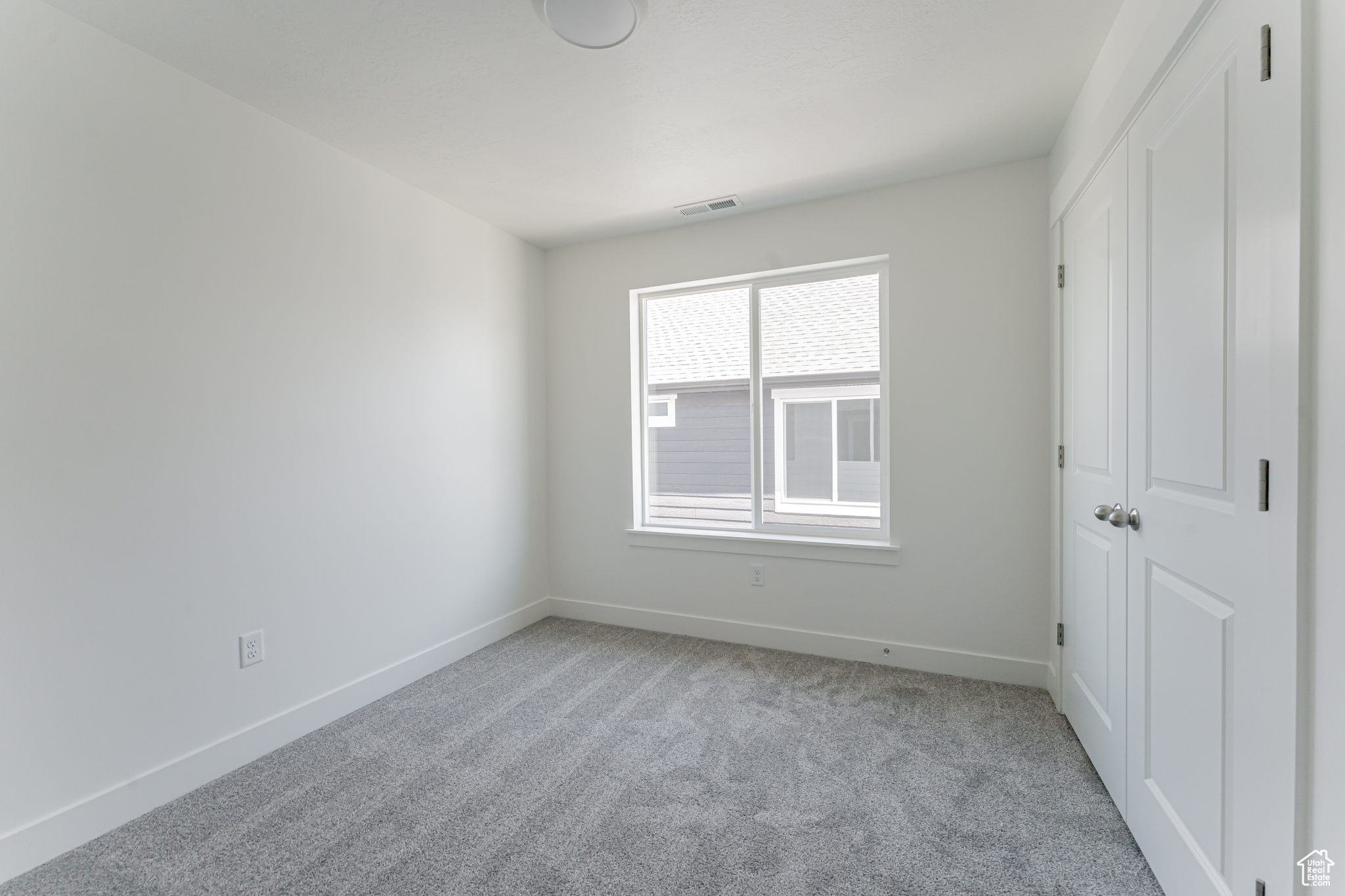 Unfurnished bedroom featuring light carpet